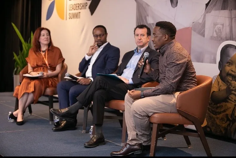 Aloyce speaking on a panel