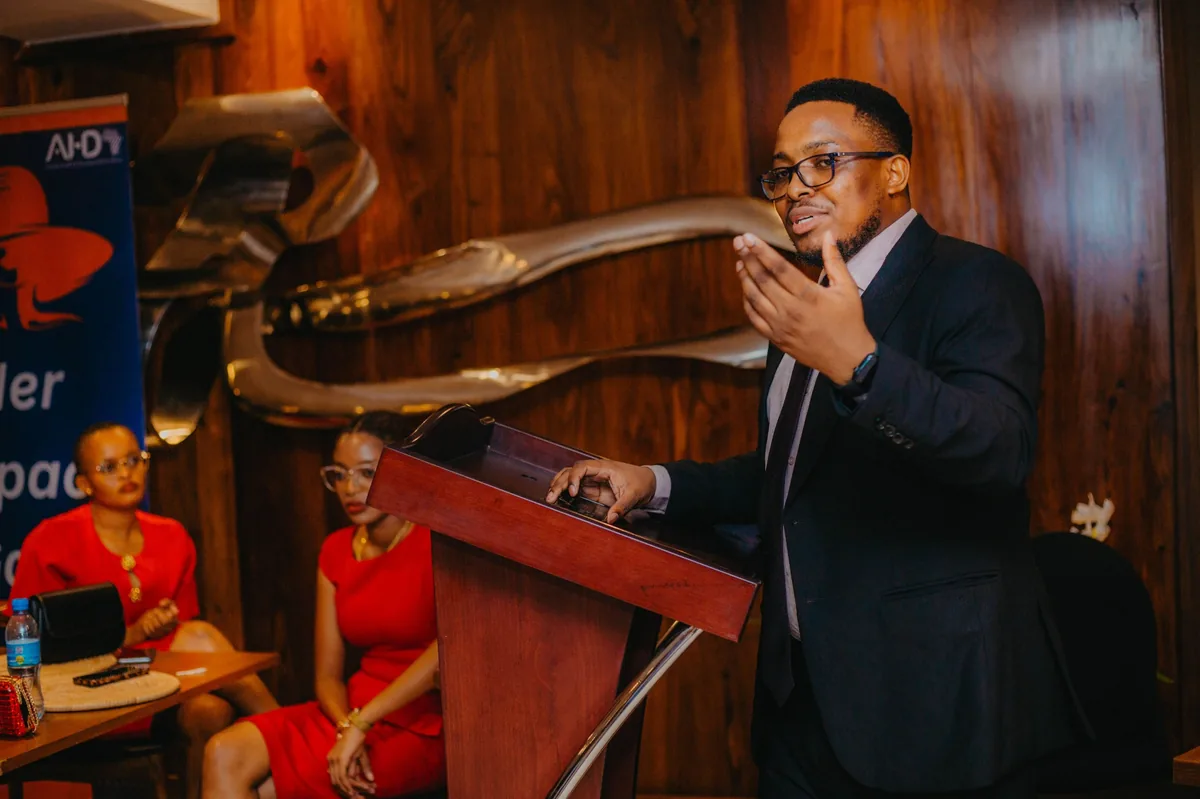 Aloyce speaking at an event