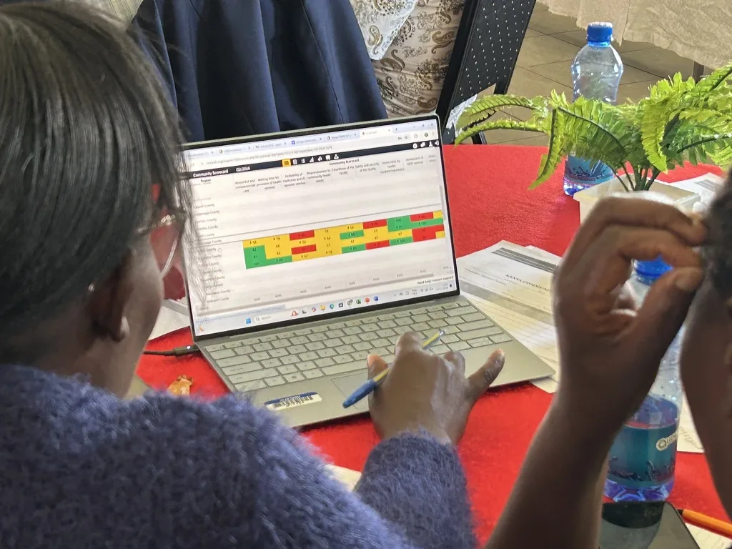 Participants reviewing a digital scorecard during training